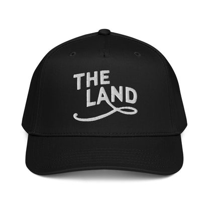 Black cap with 'THE LAND' text on a white background