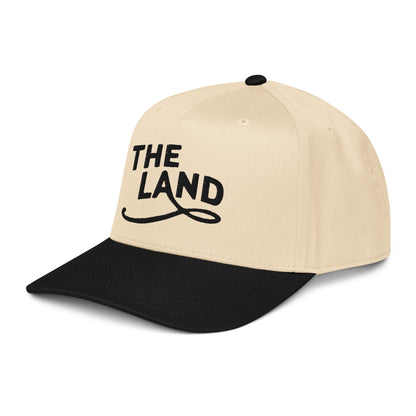 Beige and black cap with 'THE LAND' text on a white background