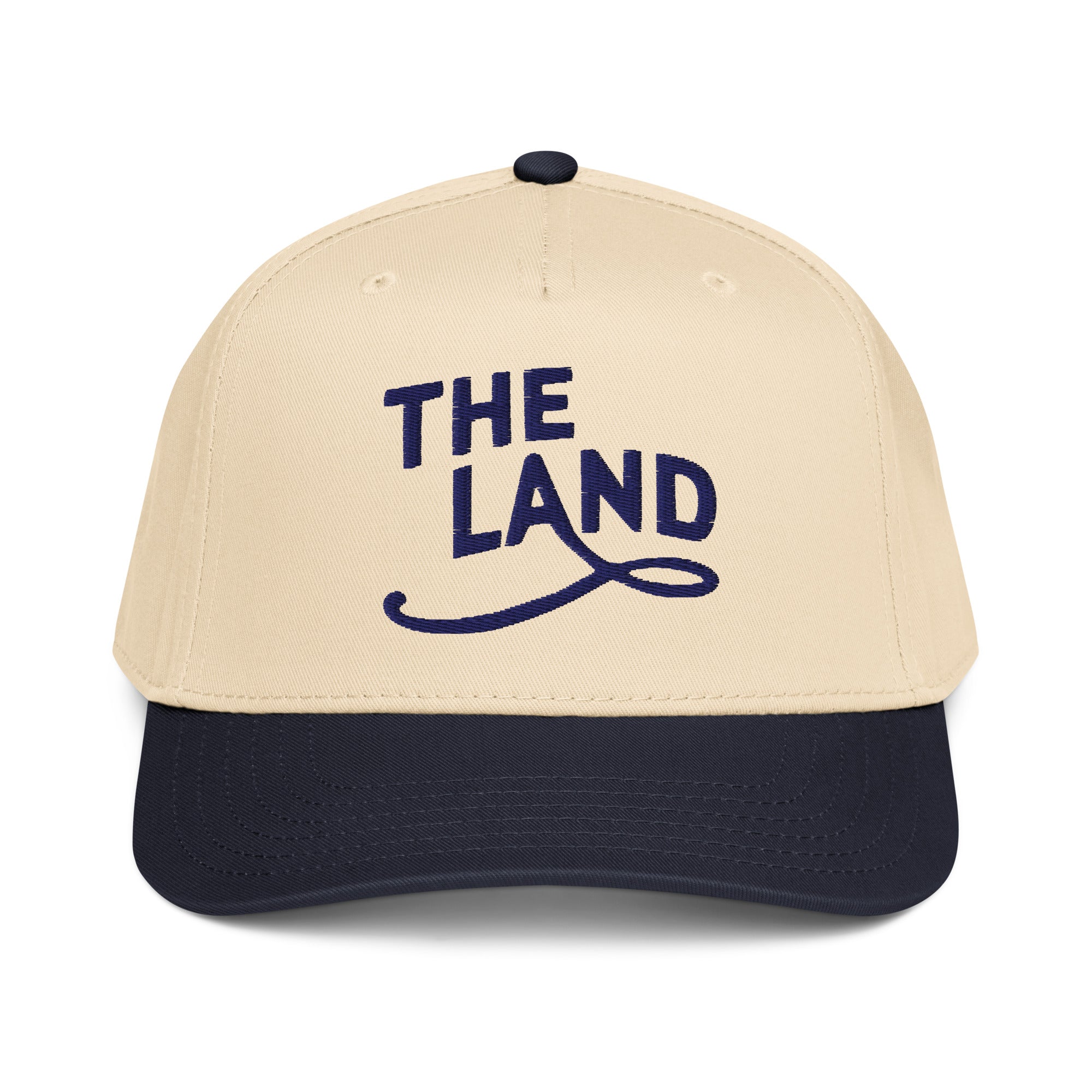 Beige and navy cap with 'THE LAND' text on a white background
